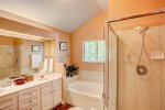 En suite master bathroom with garden tub and 2 sinks with walk in closet